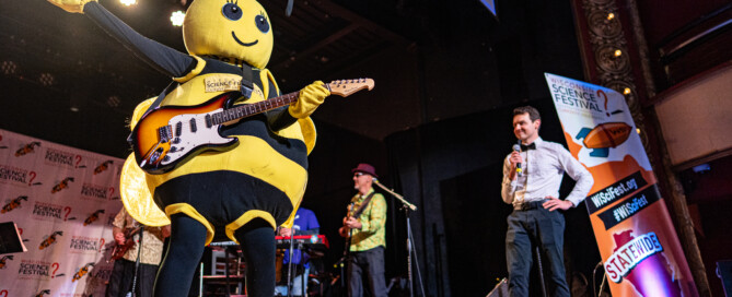 Beesly playing guitar at the WISciVariety show in 2025