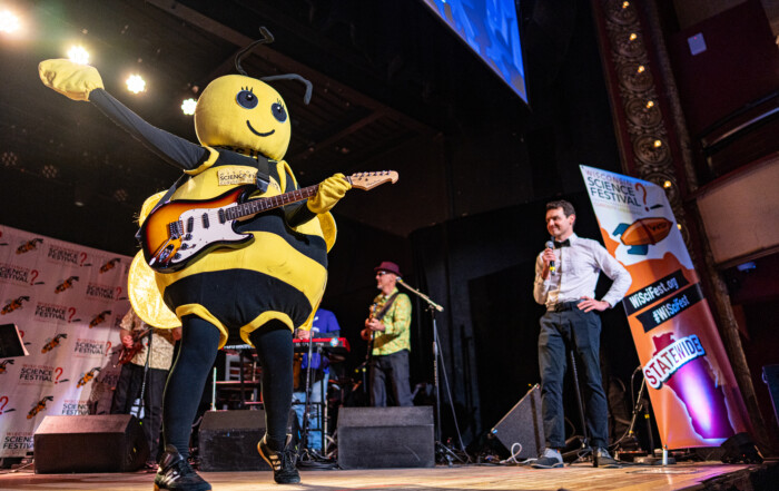 Beesly playing guitar at the WISciVariety show in 2025